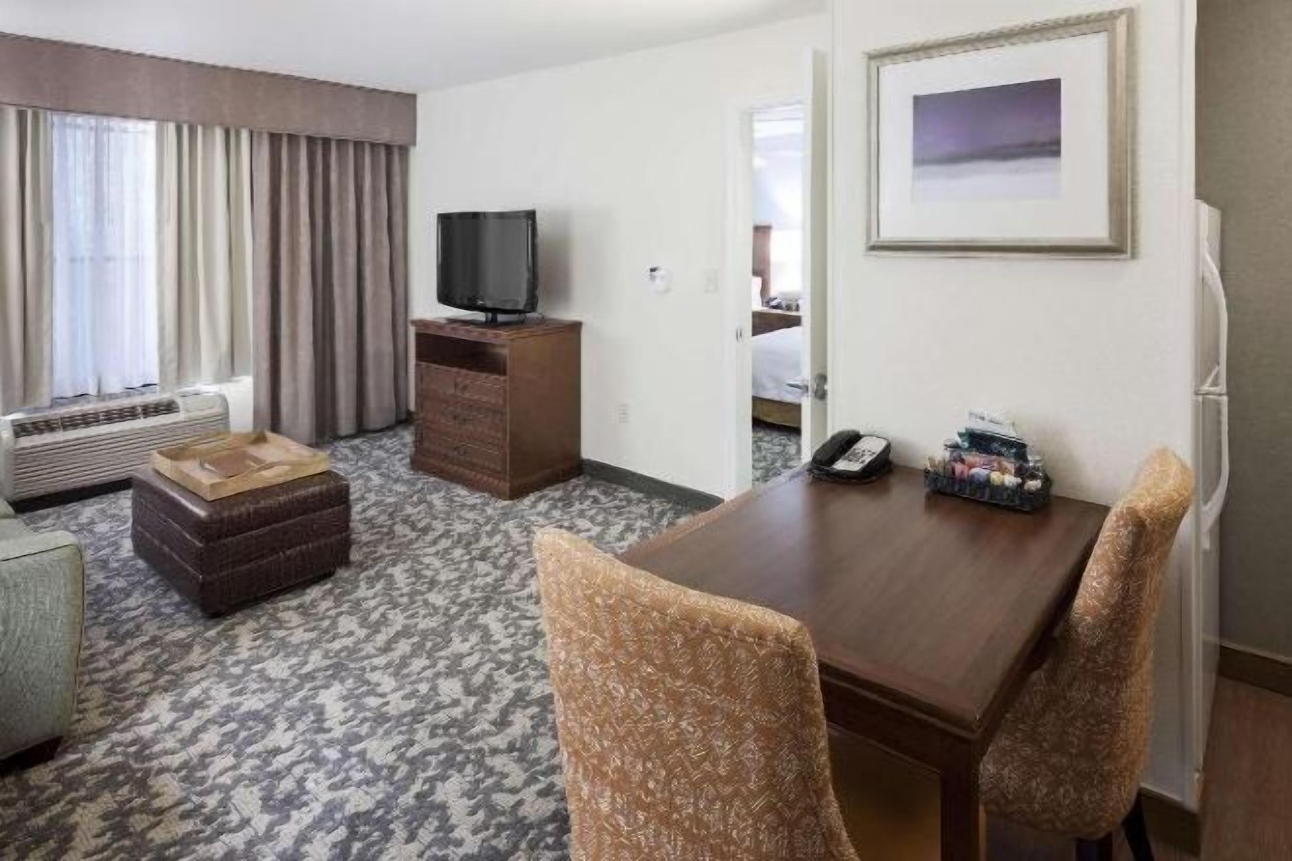 Premium bedding, desk, laptop workspace, blackout drapes