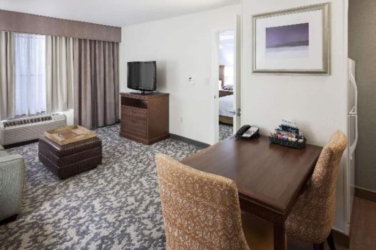 Premium bedding, desk, laptop workspace, blackout drapes