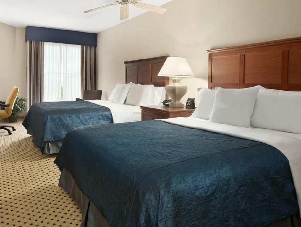 Premium bedding, desk, laptop workspace, blackout drapes