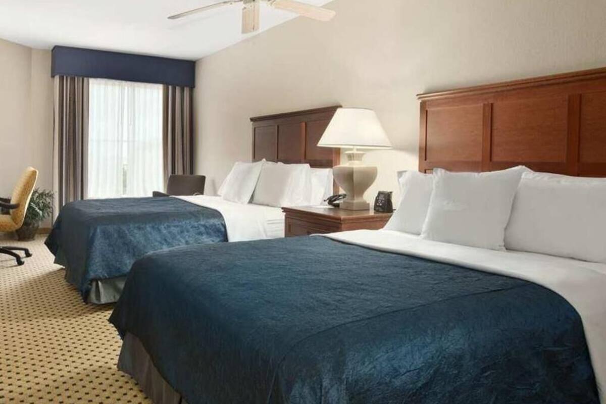 Premium bedding, desk, laptop workspace, blackout drapes