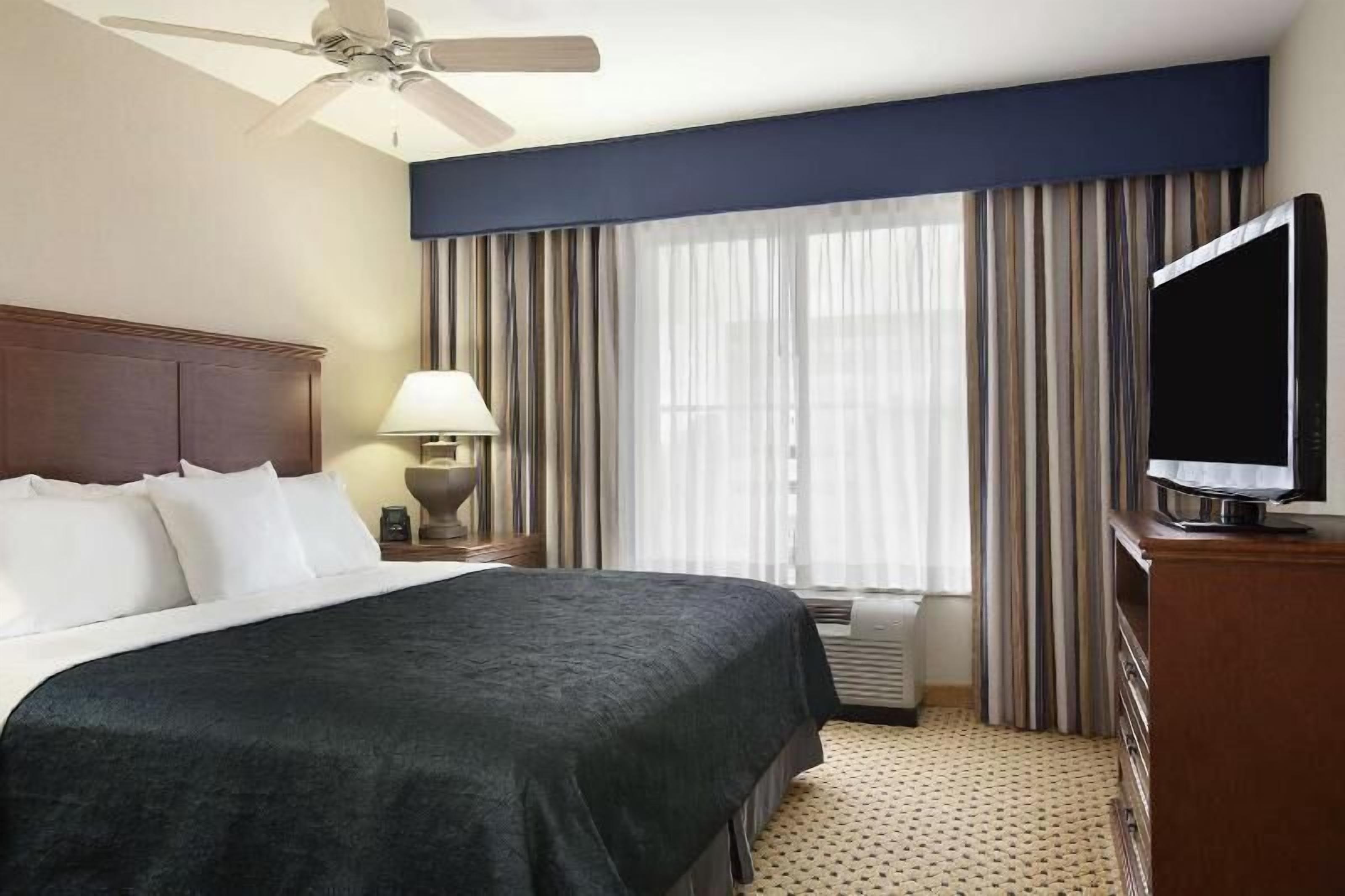 Premium bedding, desk, laptop workspace, blackout drapes