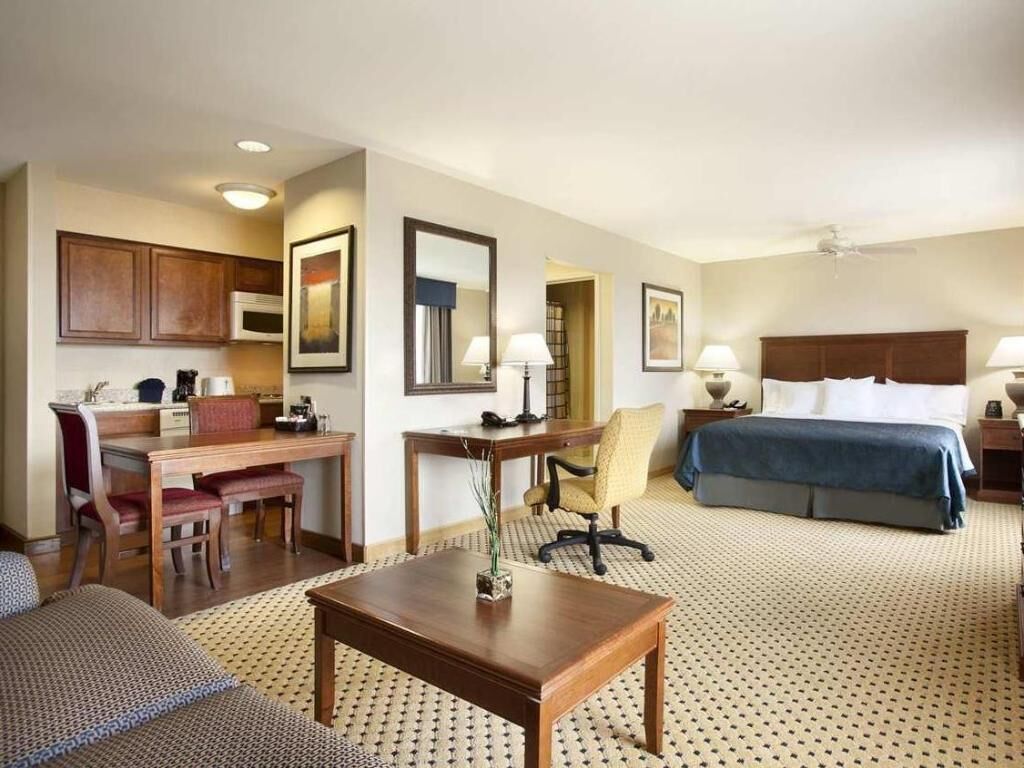Premium bedding, desk, laptop workspace, blackout drapes