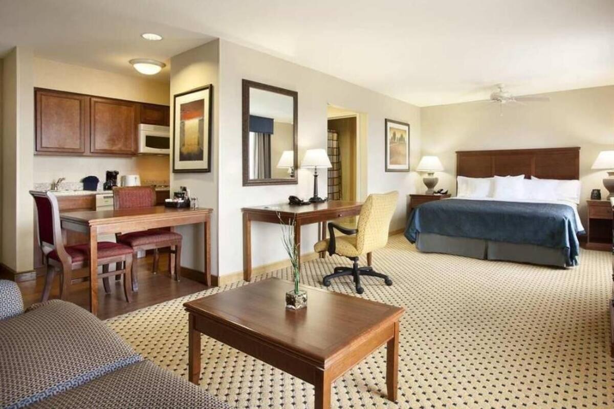 Premium bedding, desk, laptop workspace, blackout drapes