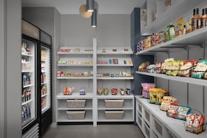 A grocery store with refrigerated and non-refrigerated sections, shelves stocked with various products, and baskets for shopping. - Homewood Suites by Hilton Houston Stafford Sugar Land (Stafford)