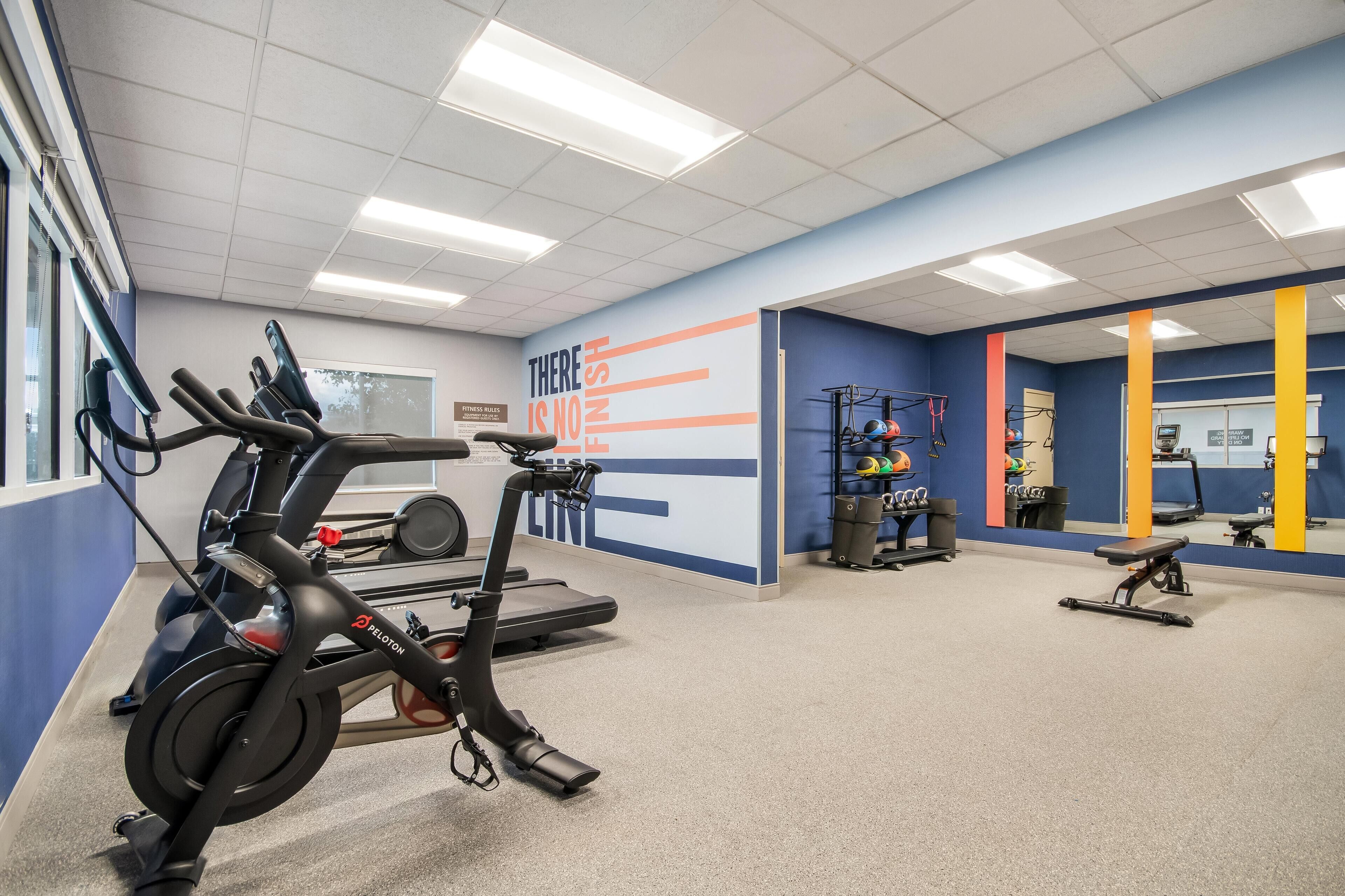A gym with stationary bikes, treadmills, and weight machines.