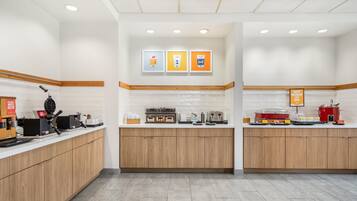 A modern kitchen with wooden cabinets, a coffee machine, and a toaster.