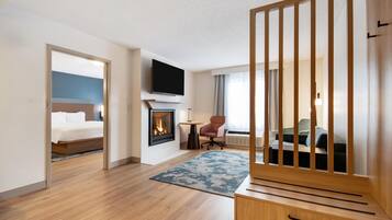 Suite, 1 King Bed, Jetted Tub | Living area | 32-inch LCD TV with cable channels, TV, pay movies