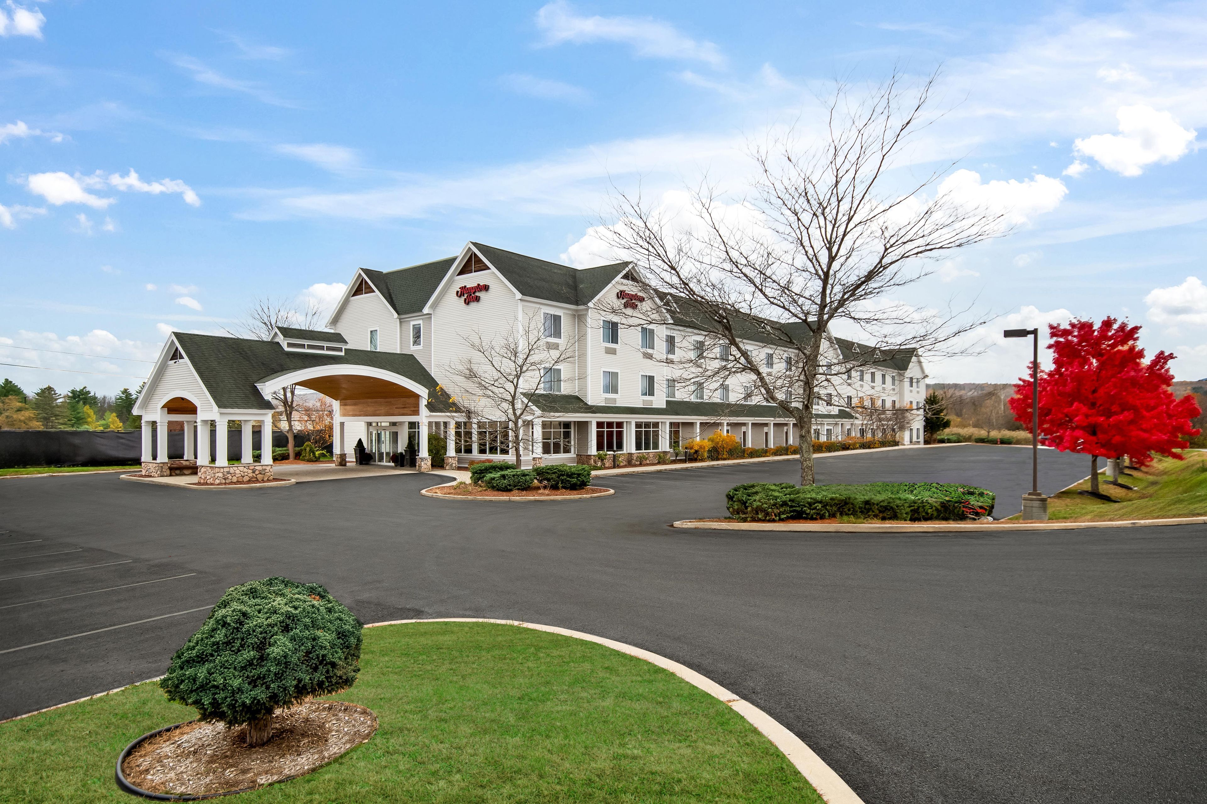 A large, multi-story hotel with a prominent entrance and a well-maintained lawn.