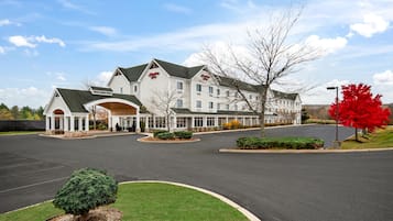 A large, multi-story hotel with a prominent entrance and a well-maintained lawn.