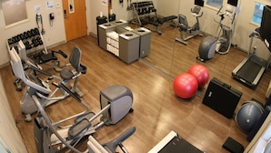A gym with various exercise equipment, including treadmills, stationary bikes, and dumbbells. - Holiday Inn Express & Suites Cheney by IHG (Cheney)