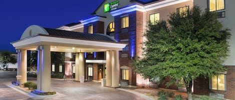 A Holiday Inn Express hotel with a covered entrance, brick facade, and landscaped area.