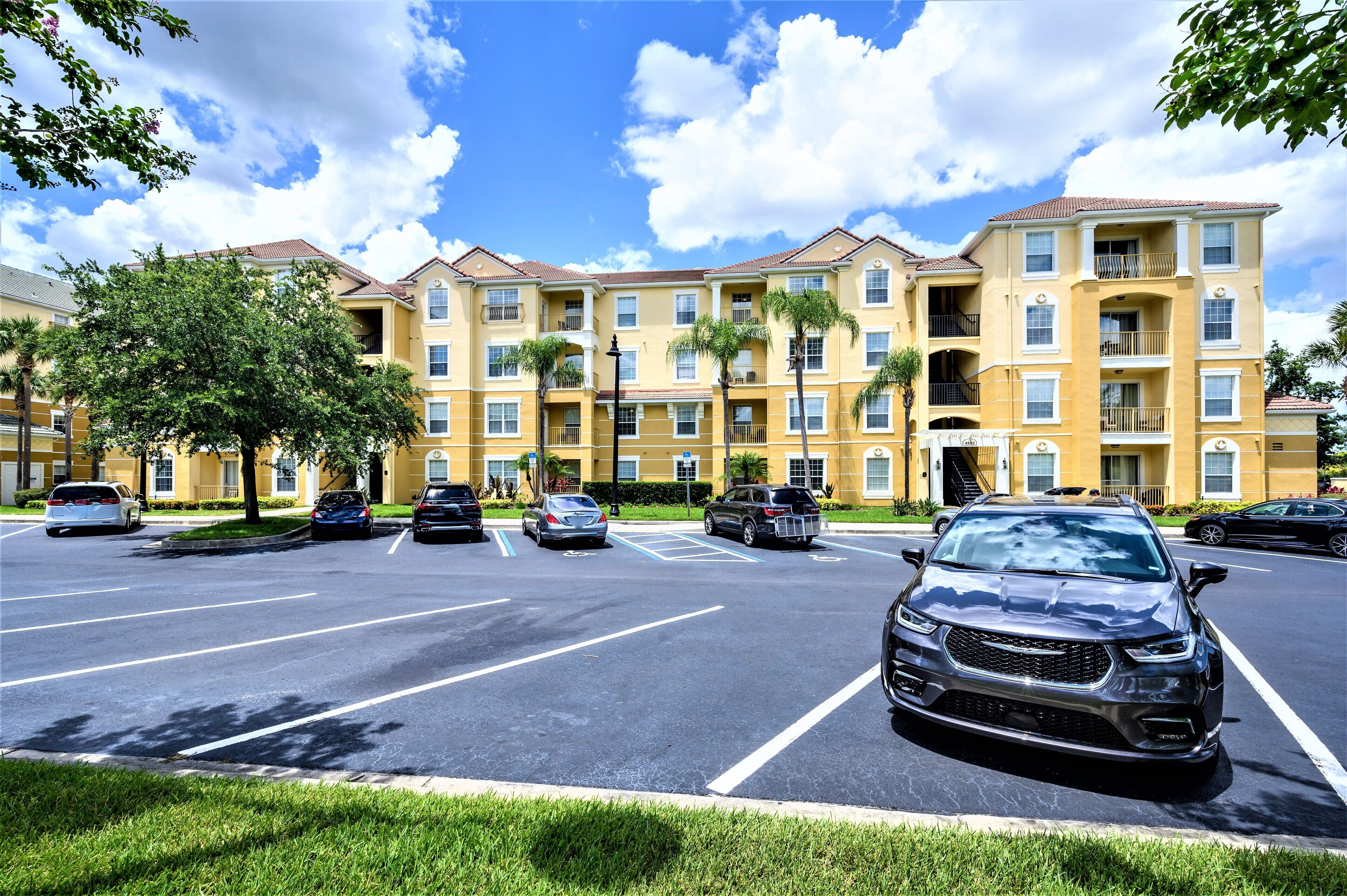 A multi-story parking garage with several cars parked.