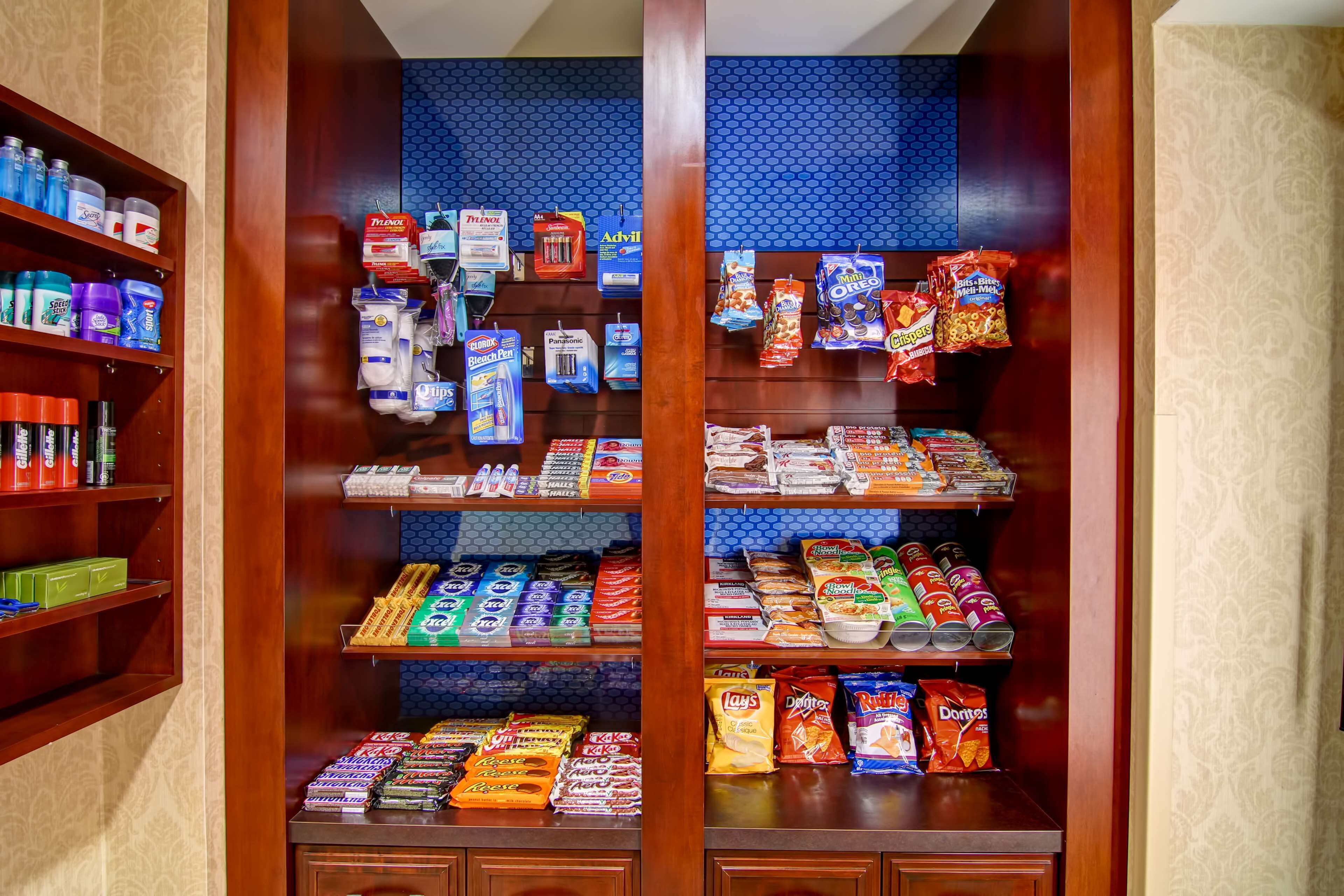 A well-organized pantry with shelves stocked with various food items and household products.