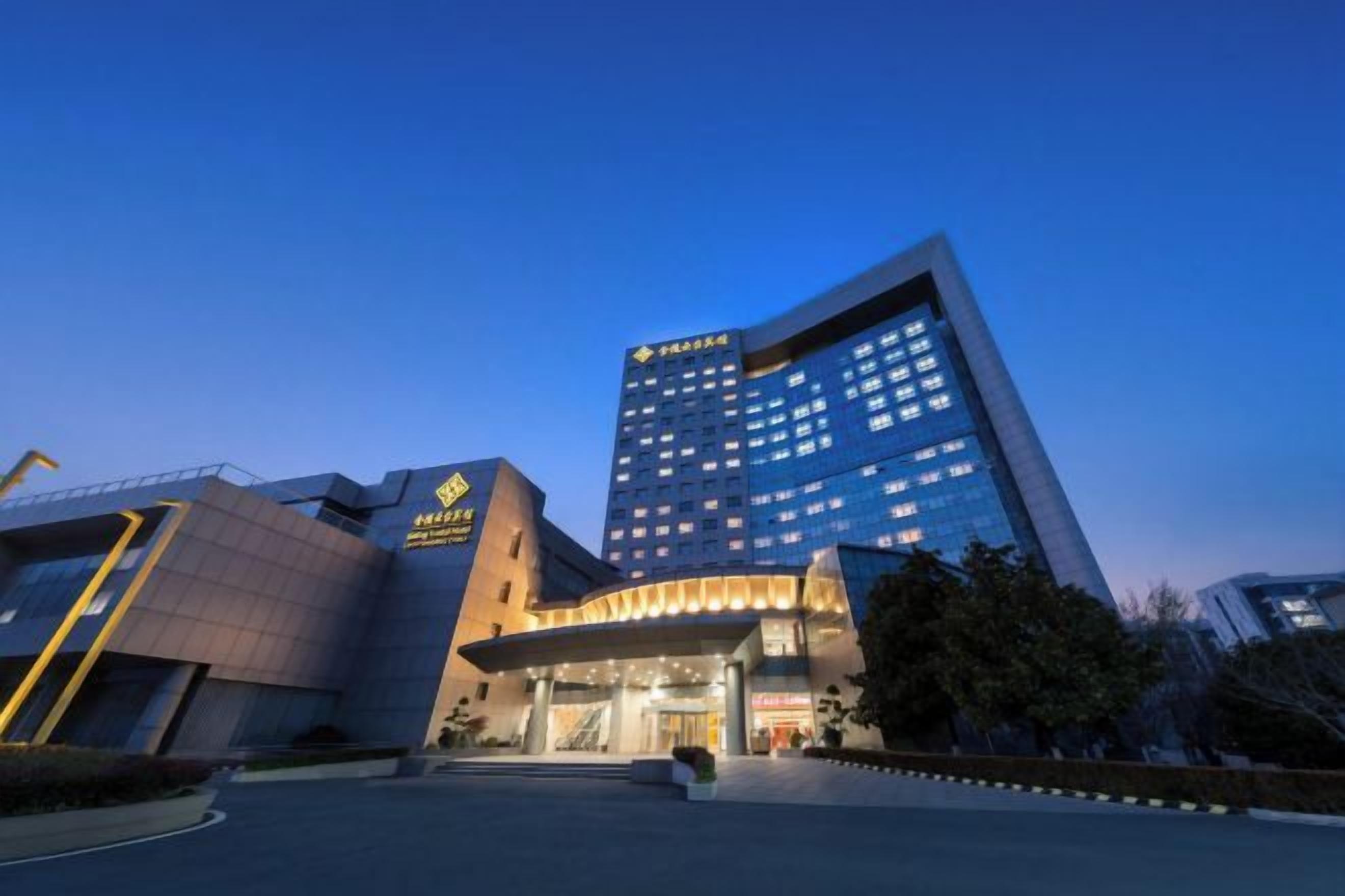 A modern hotel building with a prominent entrance and multiple floors.