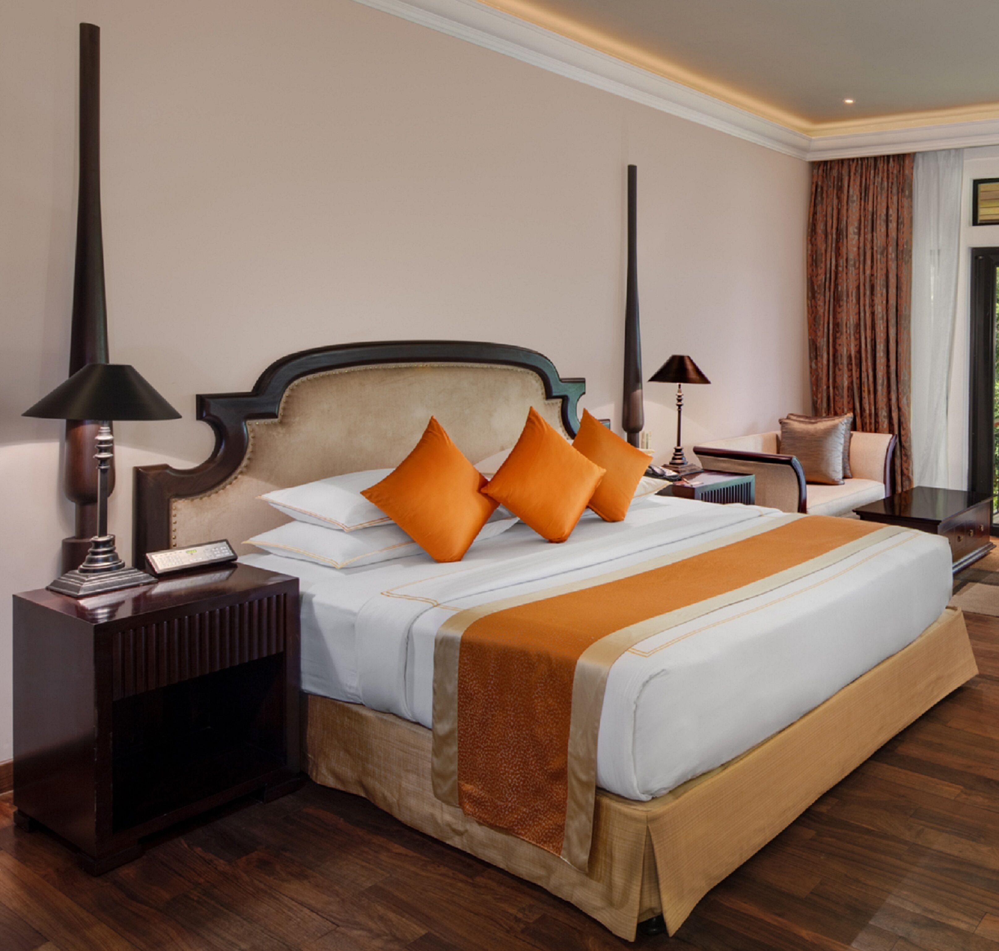 A large bed with a wooden frame, two bedside tables, and a nightstand.
