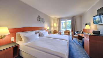 A hotel room with two beds, a desk, a chair, a TV, and a balcony with curtains.