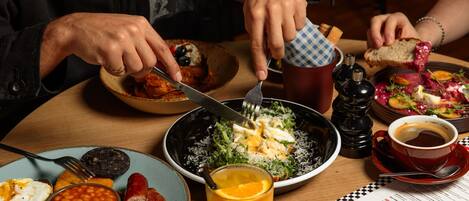 A dining table with various dishes, including eggs, beans, and a salad.