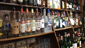A bar with shelves stocked with various liquor bottles and glasses. - The Inn at Starlight Lake (Starlight)