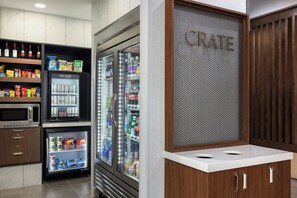 A kitchenette with a microwave, refrigerator, and a 'CRATE' sign. - Courtyard by Marriott Pittsburgh Monroeville (Monroeville)
