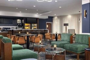 A hotel lobby with seating areas, a bar, and a reception desk. - Courtyard by Marriott Pittsburgh Monroeville (Monroeville)