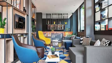 Relax in our lounge area, featuring a mix of seating, a library, and a bar, perfect for socializing and unwinding.