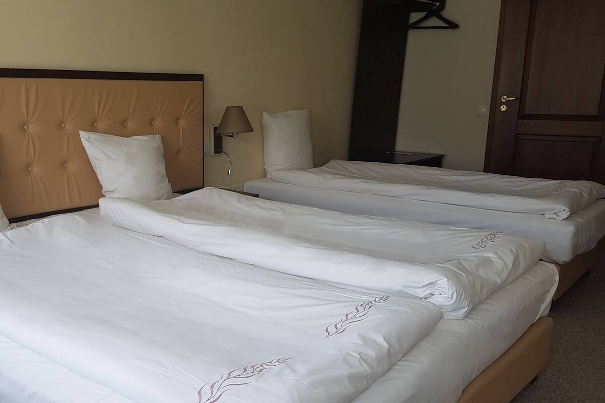 Economy Triple Room | Minibar, in-room safe, desk, blackout curtains