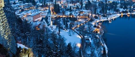 A snow-covered town with a prominent church and a lake.