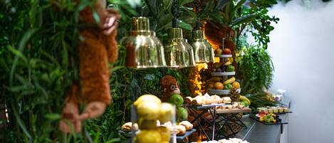 A buffet with various food items and a monkey decoration.