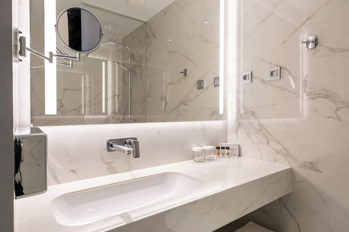 shower, hair dryer, slippers, towels