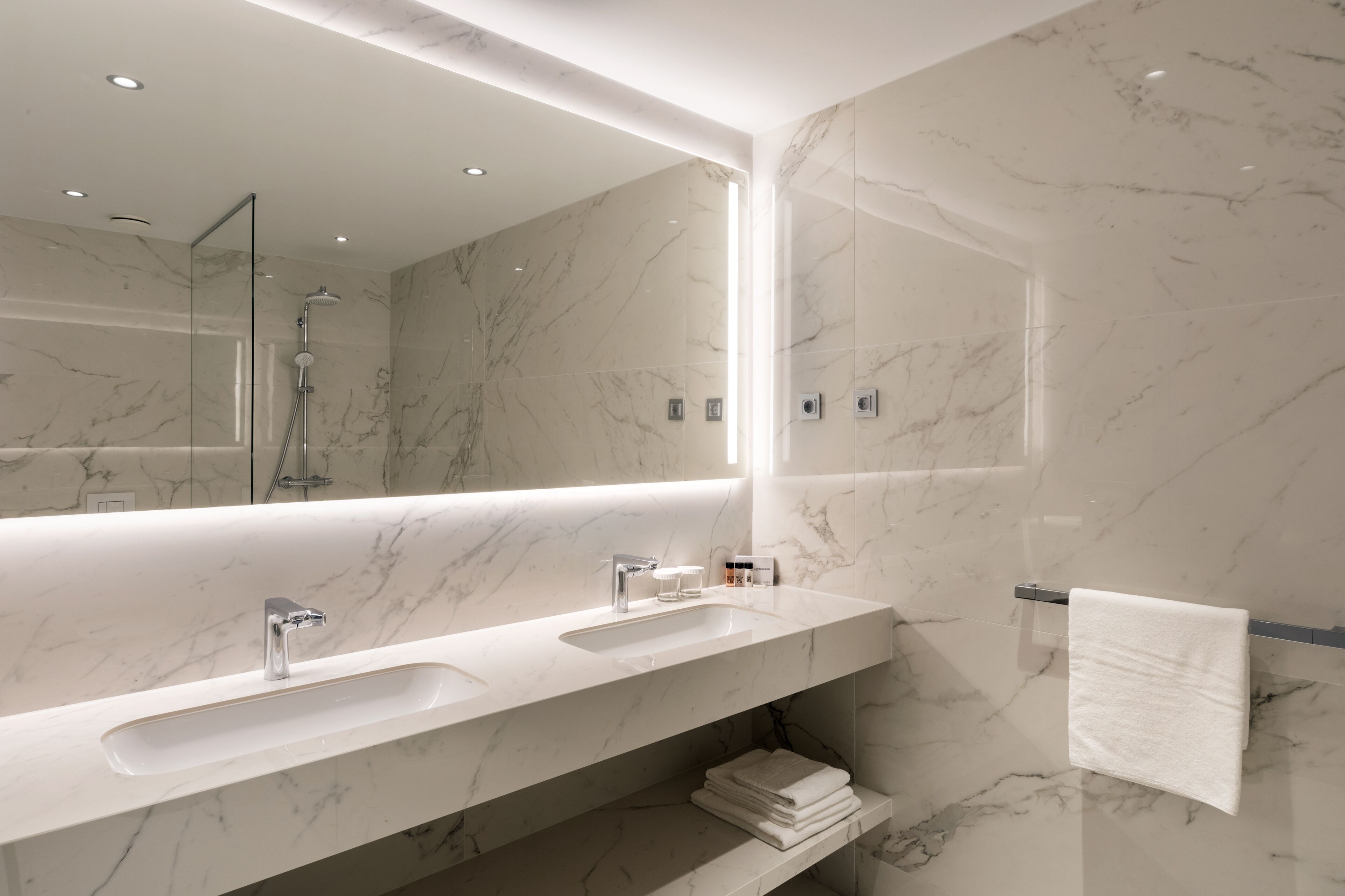 shower, hair dryer, slippers, towels