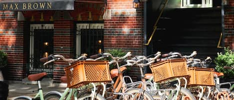 A row of bicycles parked in front of a building with a sign reading "MAX BROWN".