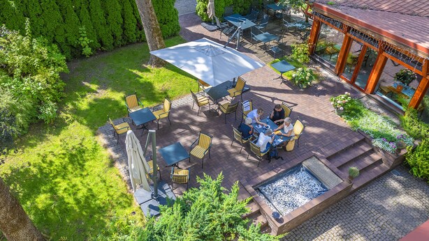 An outdoor patio area with seating, a water feature, and a covered seating area. - Grotthuss Boutique Hotel (Vilnius)