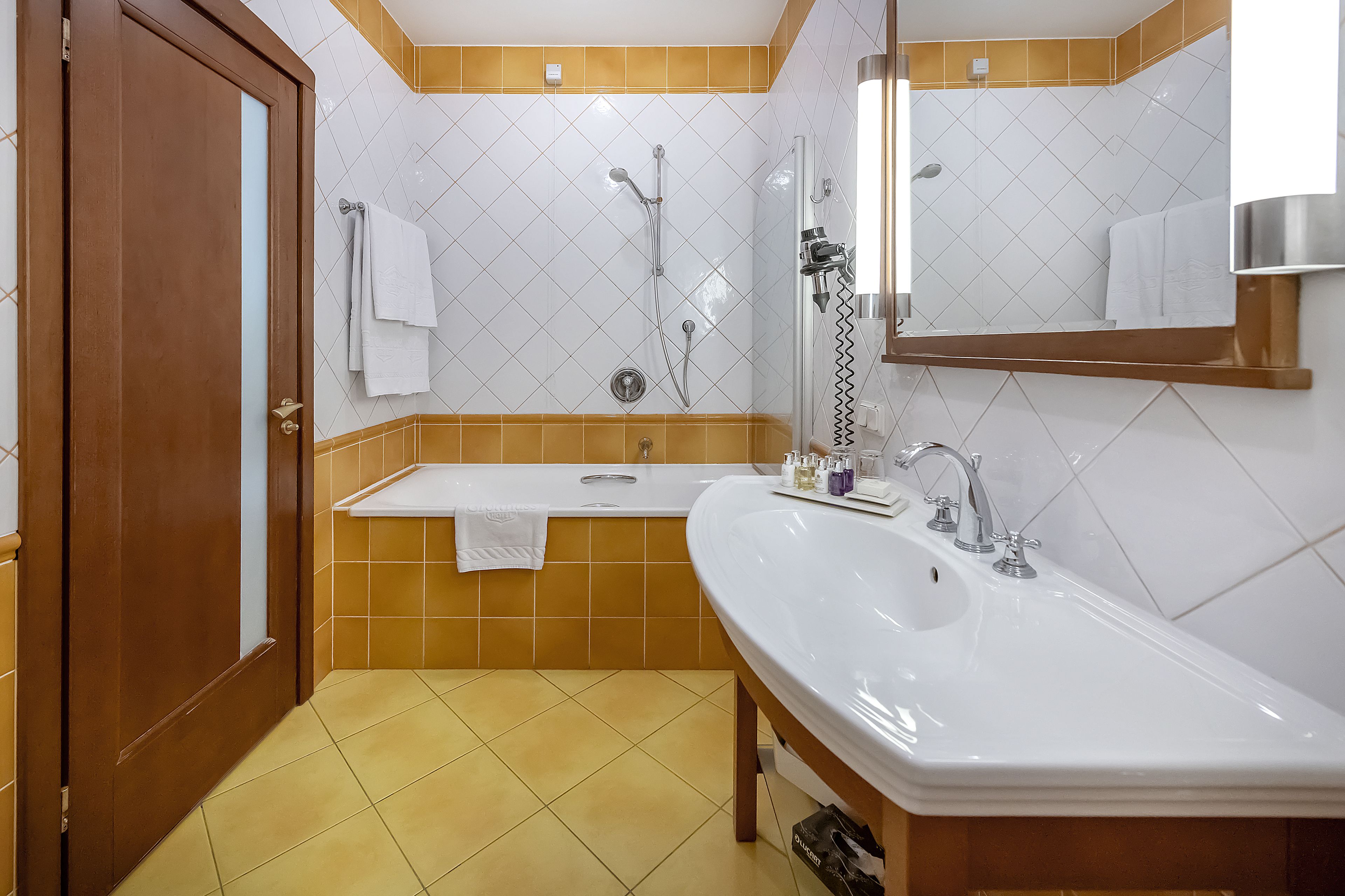 A modern bathroom with a double sink, a bathtub, and a shower.