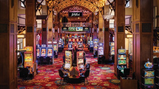 A casino interior with slot machines, a Lady Luck sign, and a red carpeted floor. - Lady Luck Casino Black Hawk - A Caesars Rewards Destination (Black Hawk)