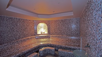 Bathroom features a unique mosaic tile design and a glass-enclosed sink.