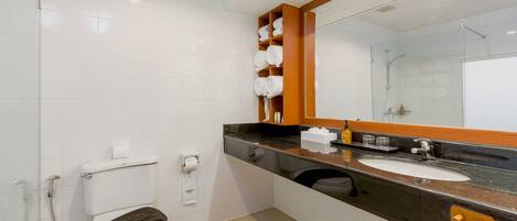 A modern bathroom with a toilet, sink, and shower.