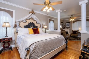 A bedroom with a four-poster bed, a ceiling fan, and a chandelier. - The Empress of Little Rock (Little Rock)
