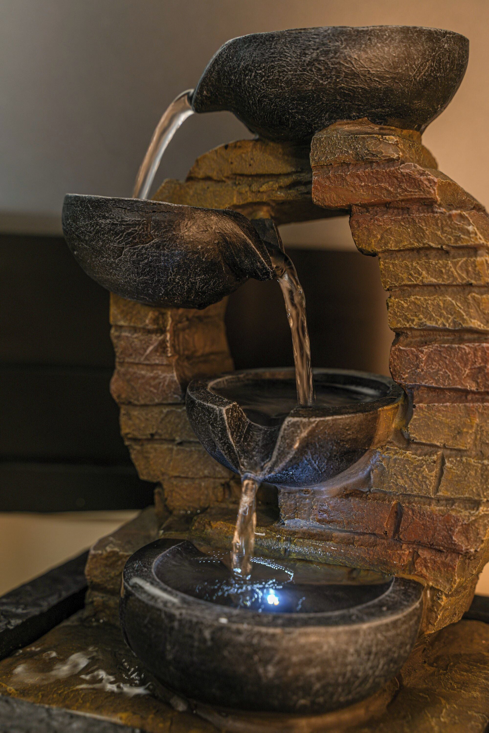 A stone water feature with a cascading design.
