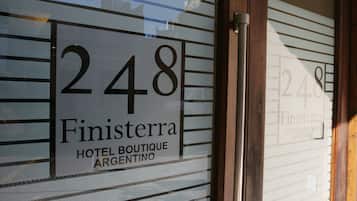 A hotel sign with the number 248 and the name 'Finisterra Hotel Boutique Argentina'.