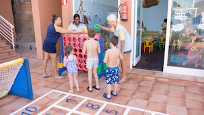 A group of children playing hopscotch on a tiled floor with a fire extinguisher mounted on the wall. - Hotel Mogan Princess & Beach Club- All Inclusive (Mogan)