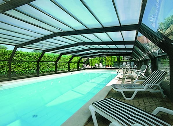 Indoor pool, seasonal outdoor pool, open 9 AM to 7 PM, pool umbrellas