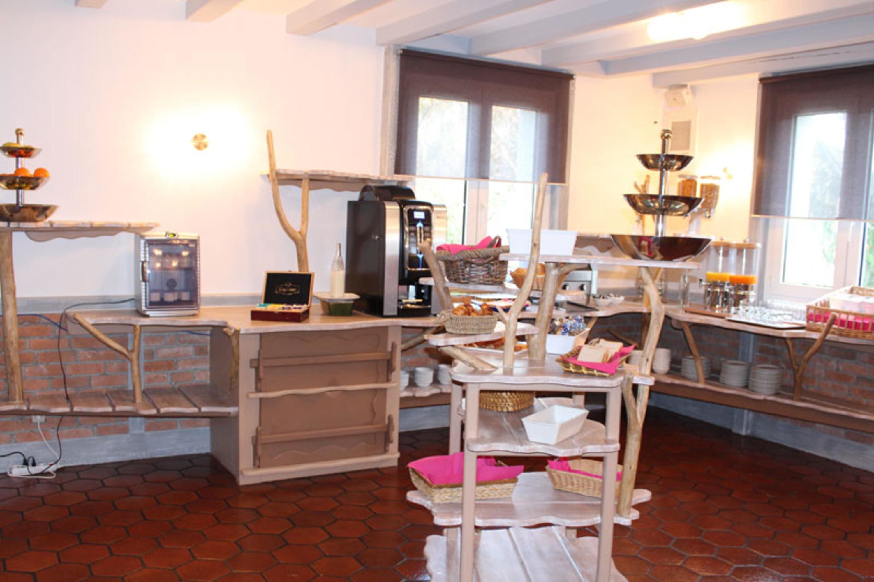 Eine Küche mit Backsteinwand, Holzregalen und einer Kaffeemaschine.