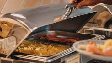 A buffet setup with a variety of food items, including a dish labeled "STRAWBERRY SHORTBREAD".
