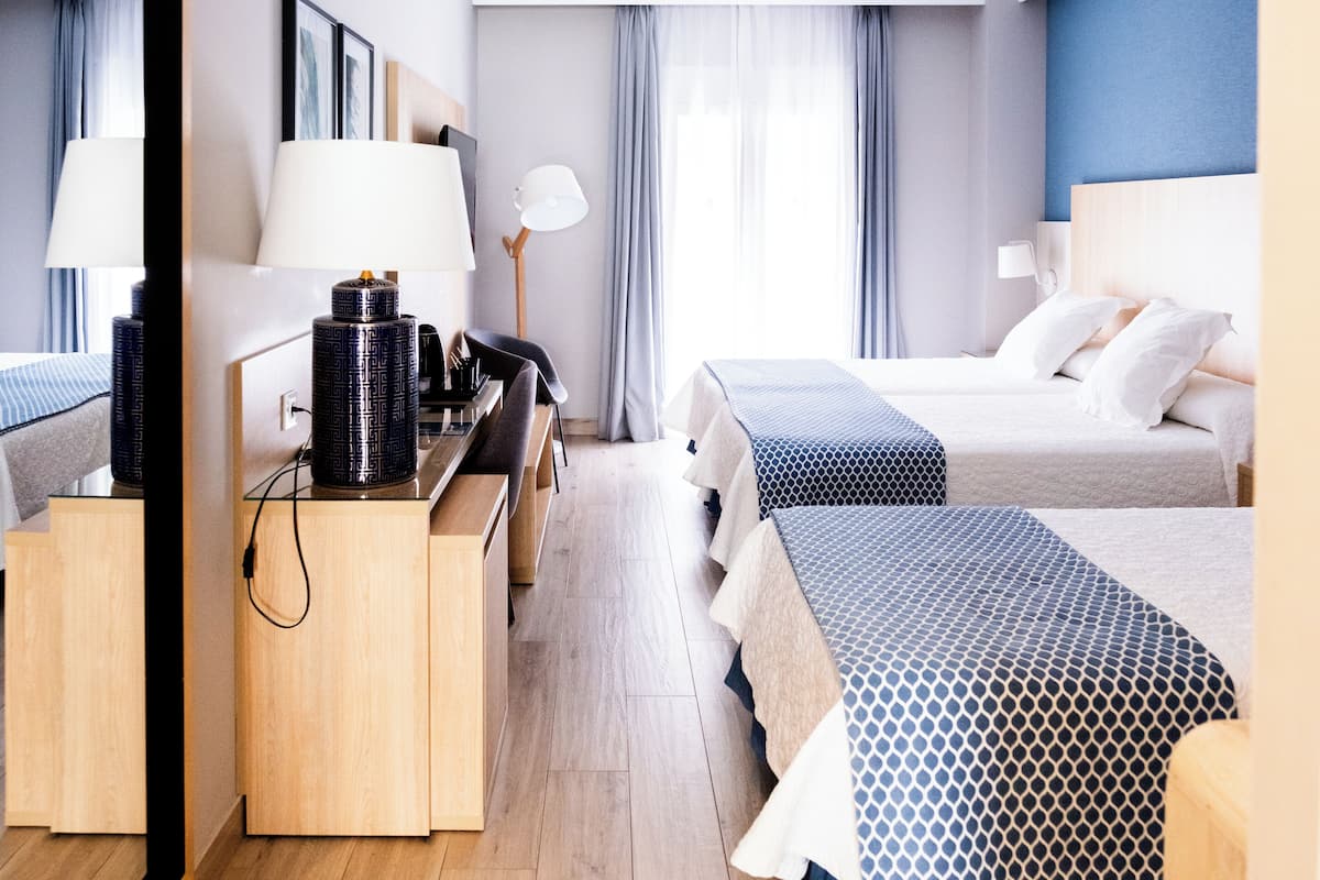 Triple Room | Minibar, in-room safe, desk, soundproofing