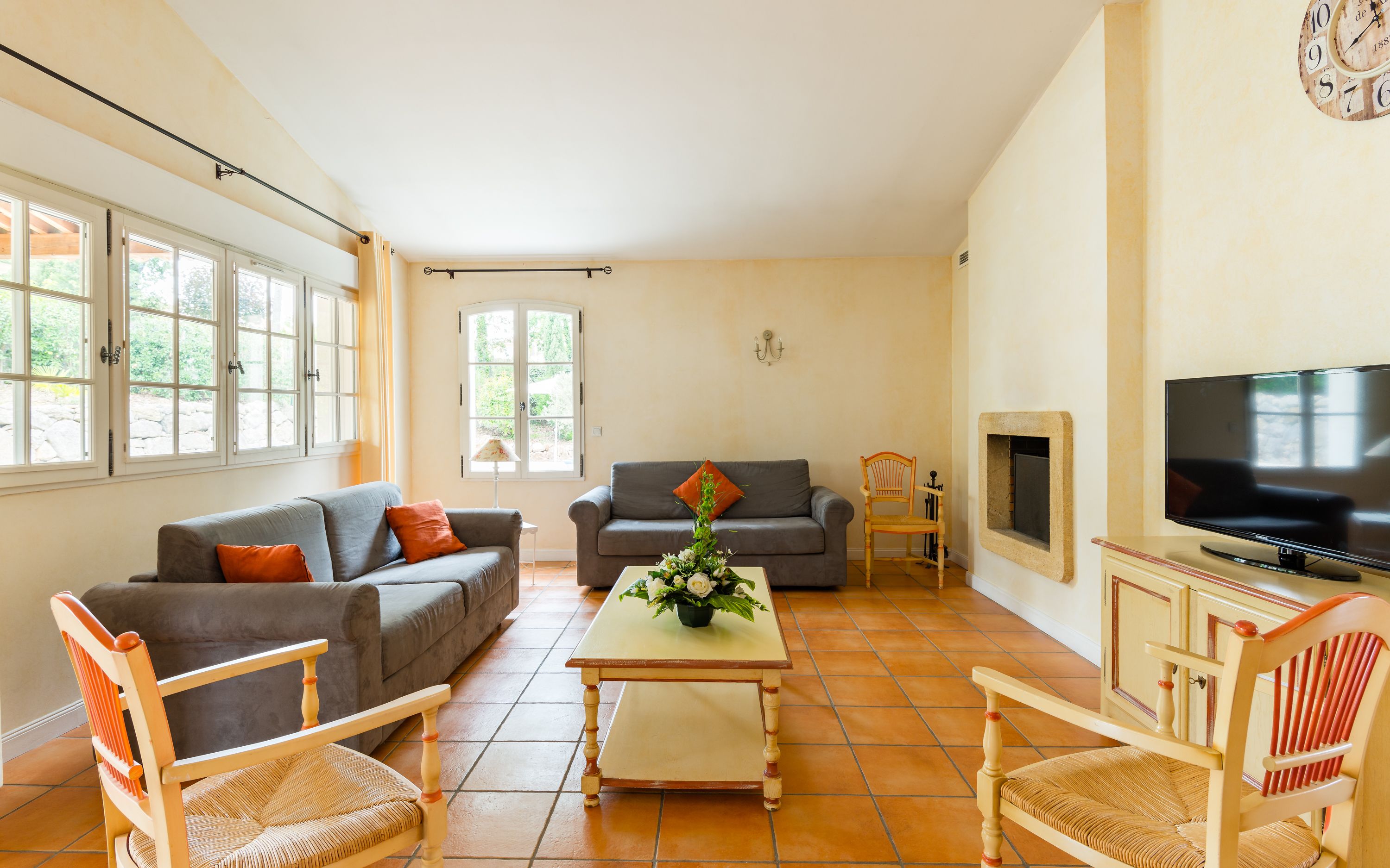 A living room with two sofas, a coffee table, a TV, and a fireplace.