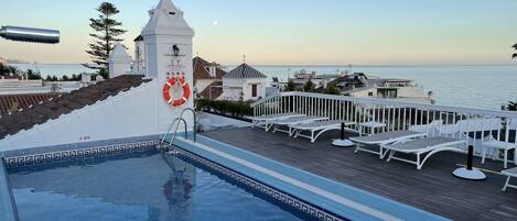 Outdoor pool, open 10:00 AM to 8:00 PM, pool umbrellas, pool loungers