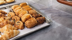 A buffet table with various pastries and a coffee dispenser. - The Originals Boutique, Hôtel Le Lion d'Or (Maen-Roch)