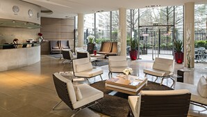 A spacious lobby with modern furniture, large windows, and a view of the outside. - Residhome Courbevoie La Défense (Courbevoie)