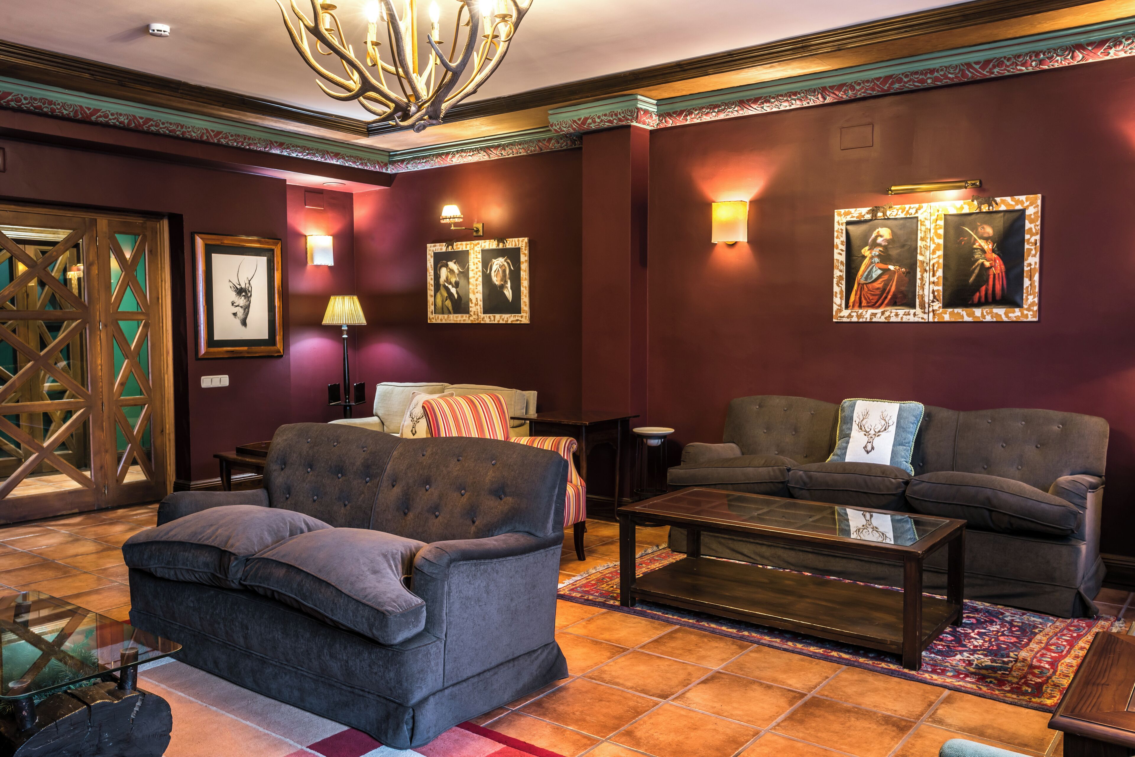 A well-appointed living room with a fireplace, comfortable seating, and decorative wall art.