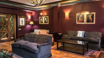 A well-appointed living room with a fireplace, comfortable seating, and decorative wall art.